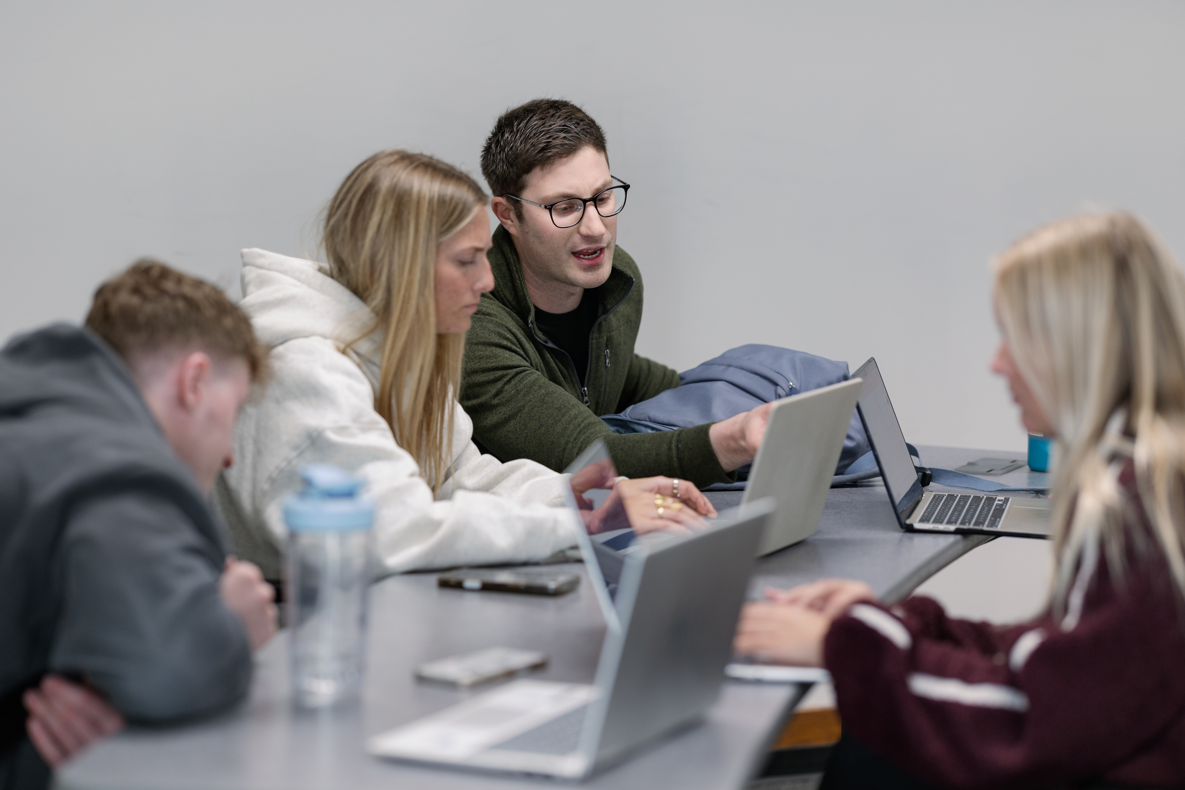 Andrew working with students around a classroom table